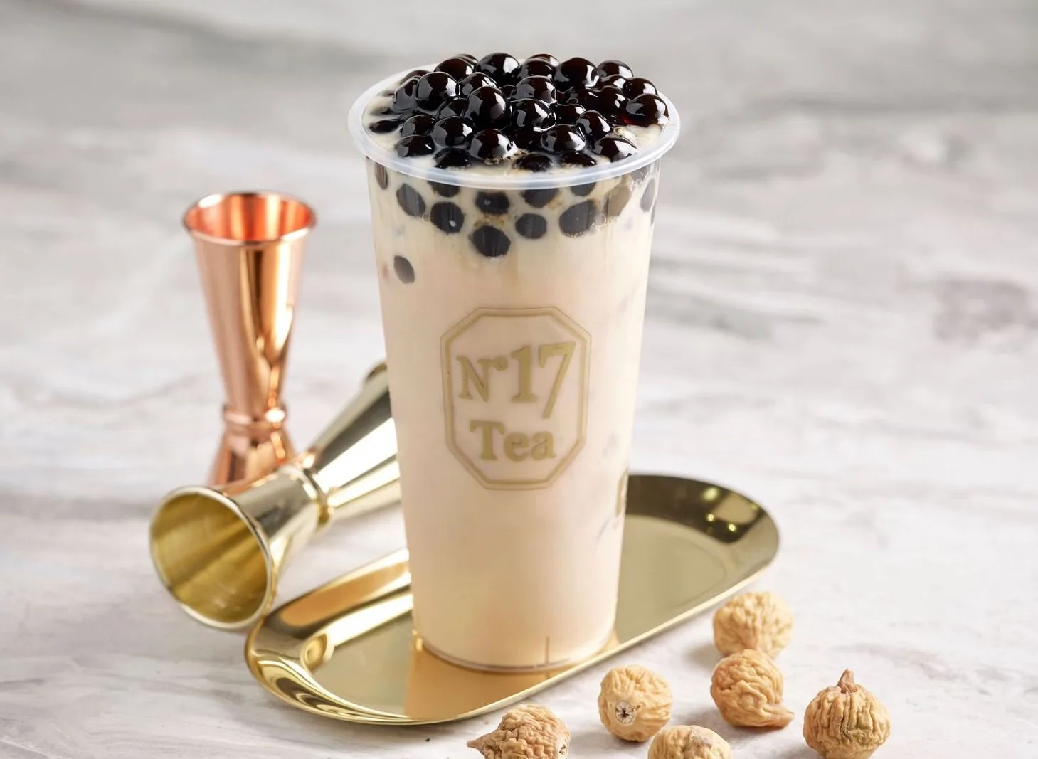 No.17 Bubble Milk Tea in a gold-logo No.17 Tea cup, topped with black boba pearls, on a gold tray